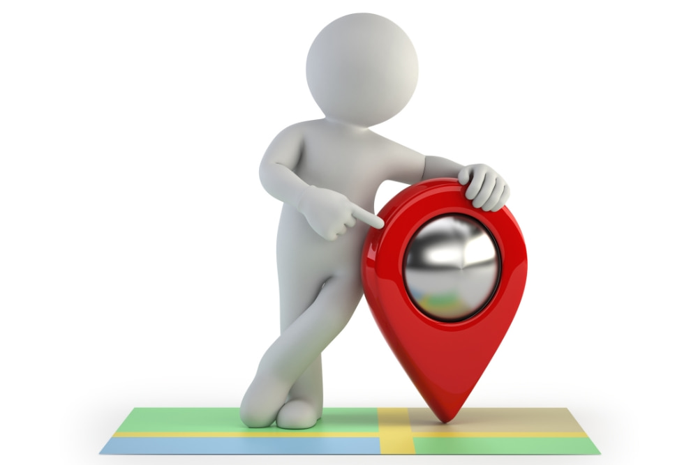 A white 3D figure points to a glossy red location pin on a colorful map strip, suggesting guidance or navigation on a clean white background.